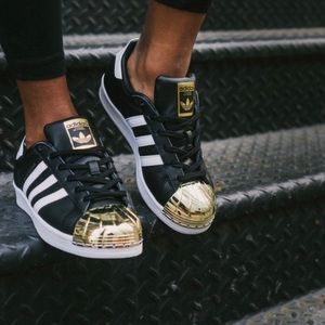 black and gold shell toe adidas